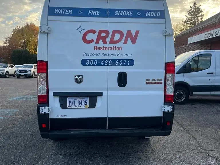 A CRDN Restoration van marked water, fire, smoke and mold