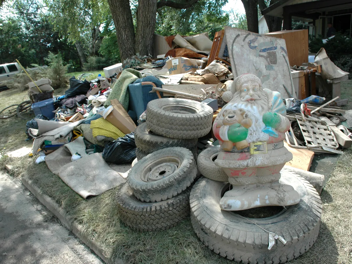 Flood-damaged belongings piled at the curb outside an Ohio home